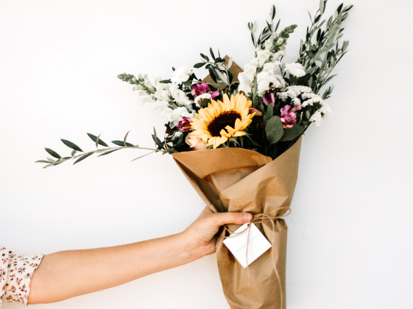 woman's hand holding a bouquet of beautiful flowers